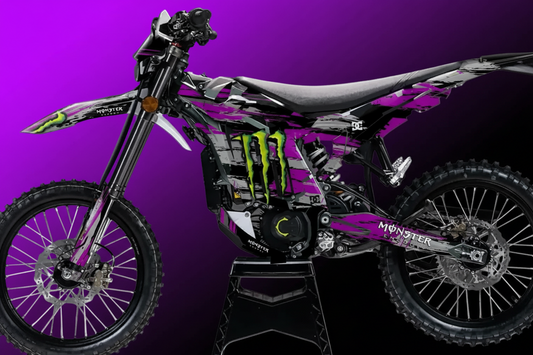 Motorcycle with purple and gray design on a stand against a dark background