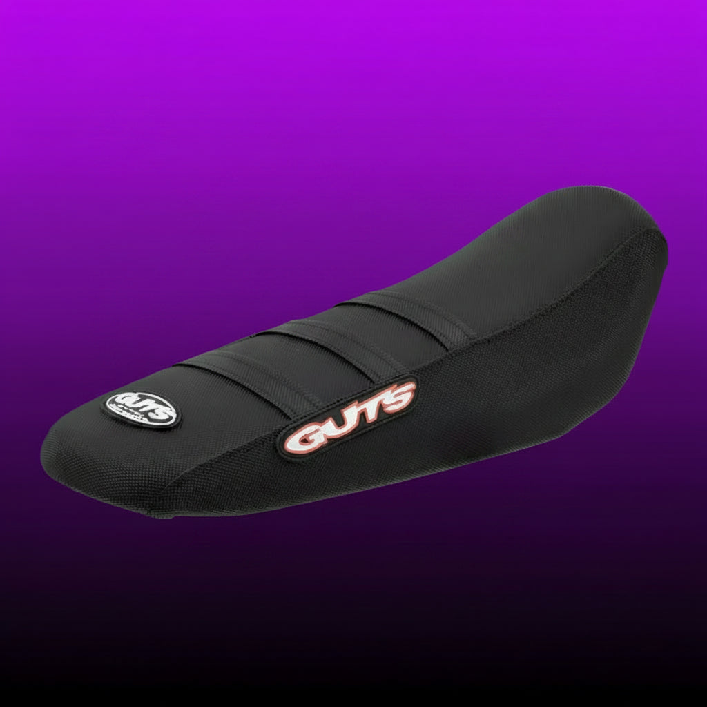 Black motorcycle seat with 'Guts' branding on a white background